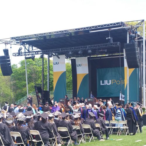 Crowd in foldable stools, Green stage for LIU Commencement