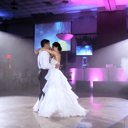 Man and woman dancing in spotlight - wedding