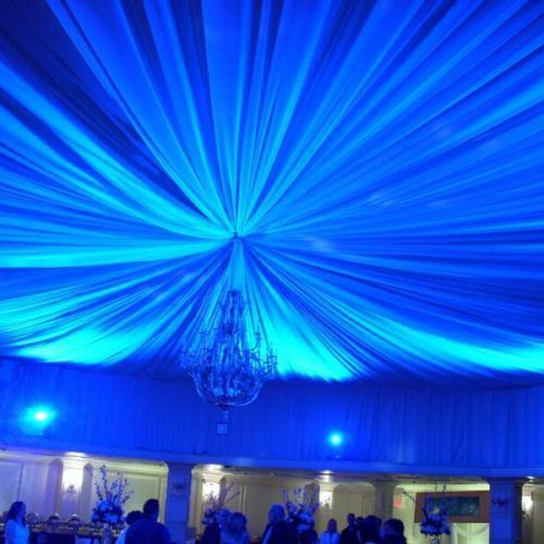Decadent ceiling and chandelier blue lighting wedding